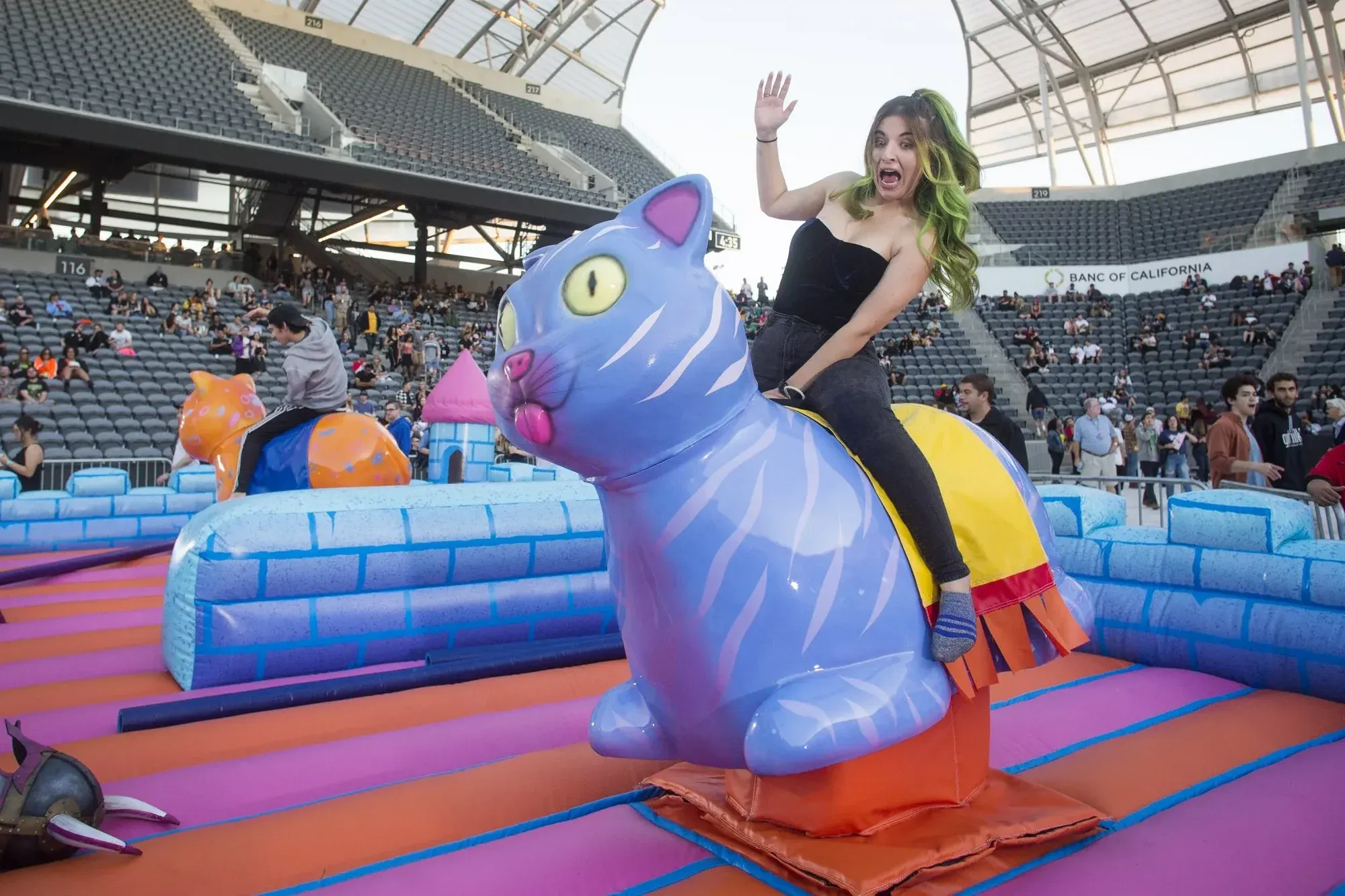 A guest riding an inflatable cat joust at Adult Swim Festival