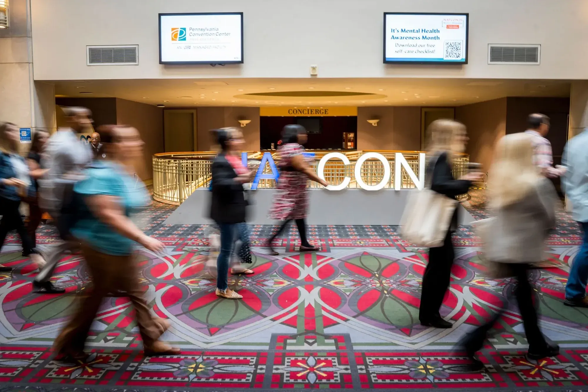 Attendees walking through the NatCon convention hall
