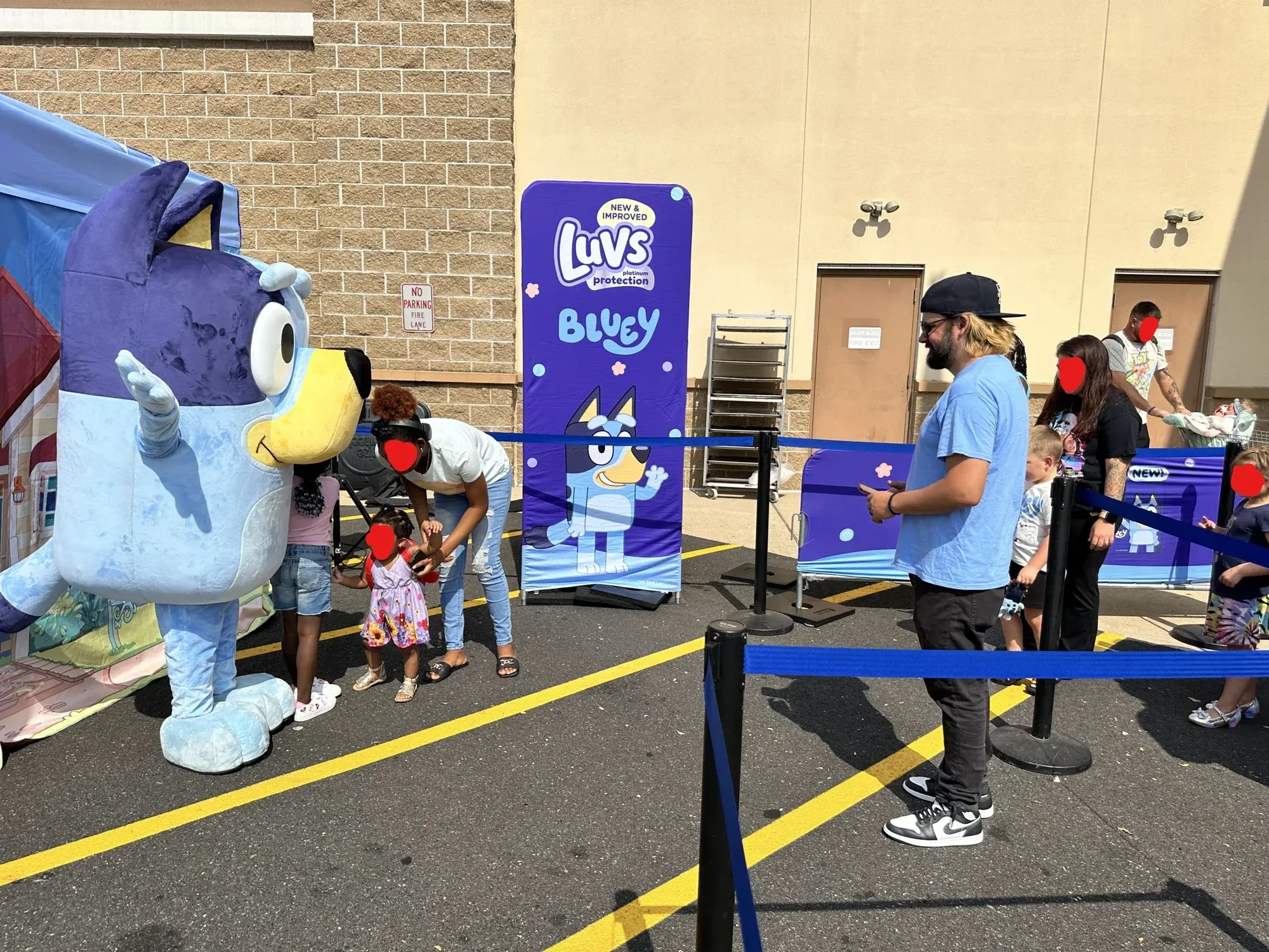 Families meeting Bluey at the Walmart meet and greet