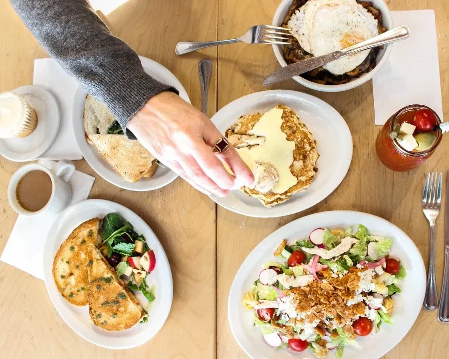 Brunch dishes shared across a table at Southport Grocery