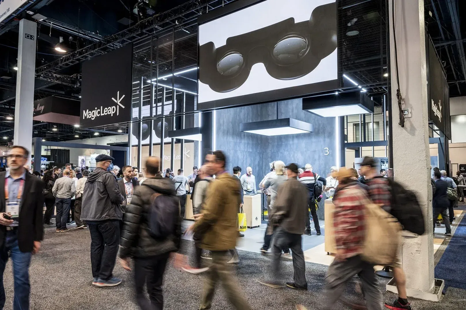 Crowds of attendees walking past the Magic Leap booth on the CES show floor