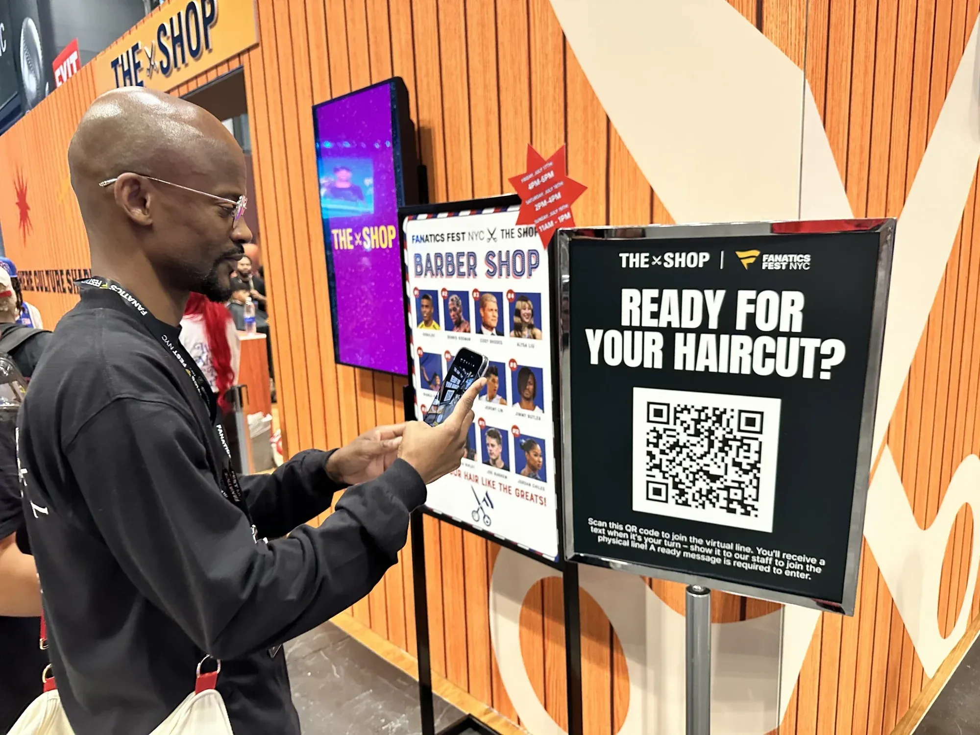 A fan scanning The Shop’s QR code to join the NextMe virtual queue