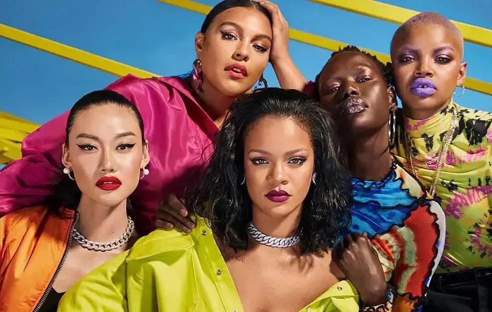 Five models wearing Fenty Beauty makeup in a bright campaign photo