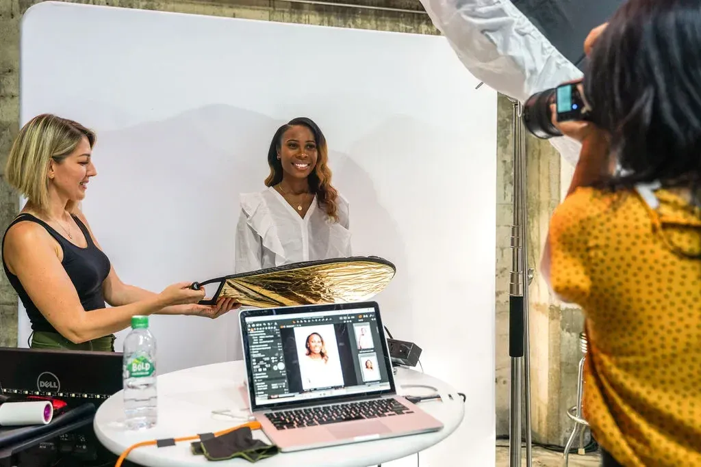 A photographer taking an attendee’s headshot