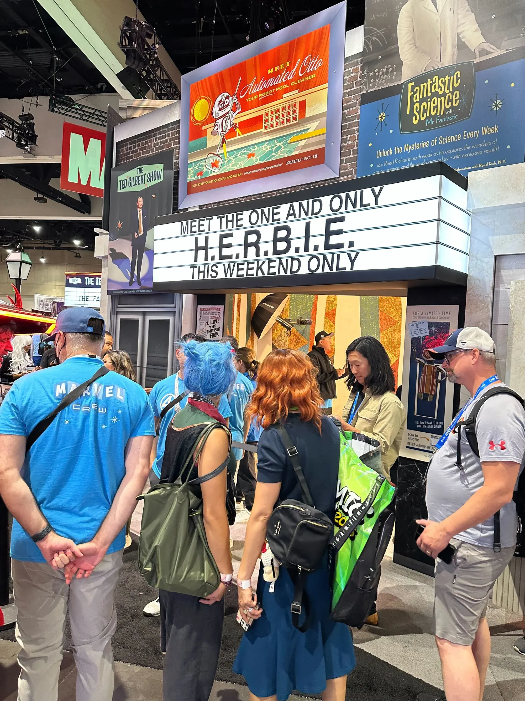 Fans in the short standby line under the Meet the One and Only H.E.R.B.I.E. marquee