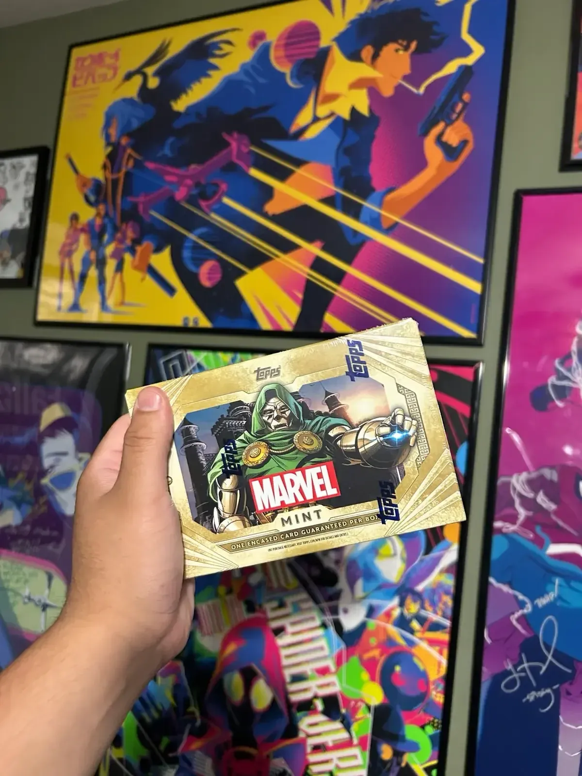 A fan holding a limited-edition Marvel Mint trading card at the Topps booth