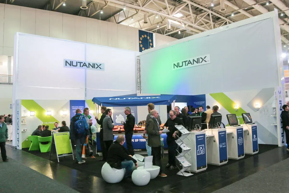 Attendees at the Nutanix booth and laptop stations at Next Conference