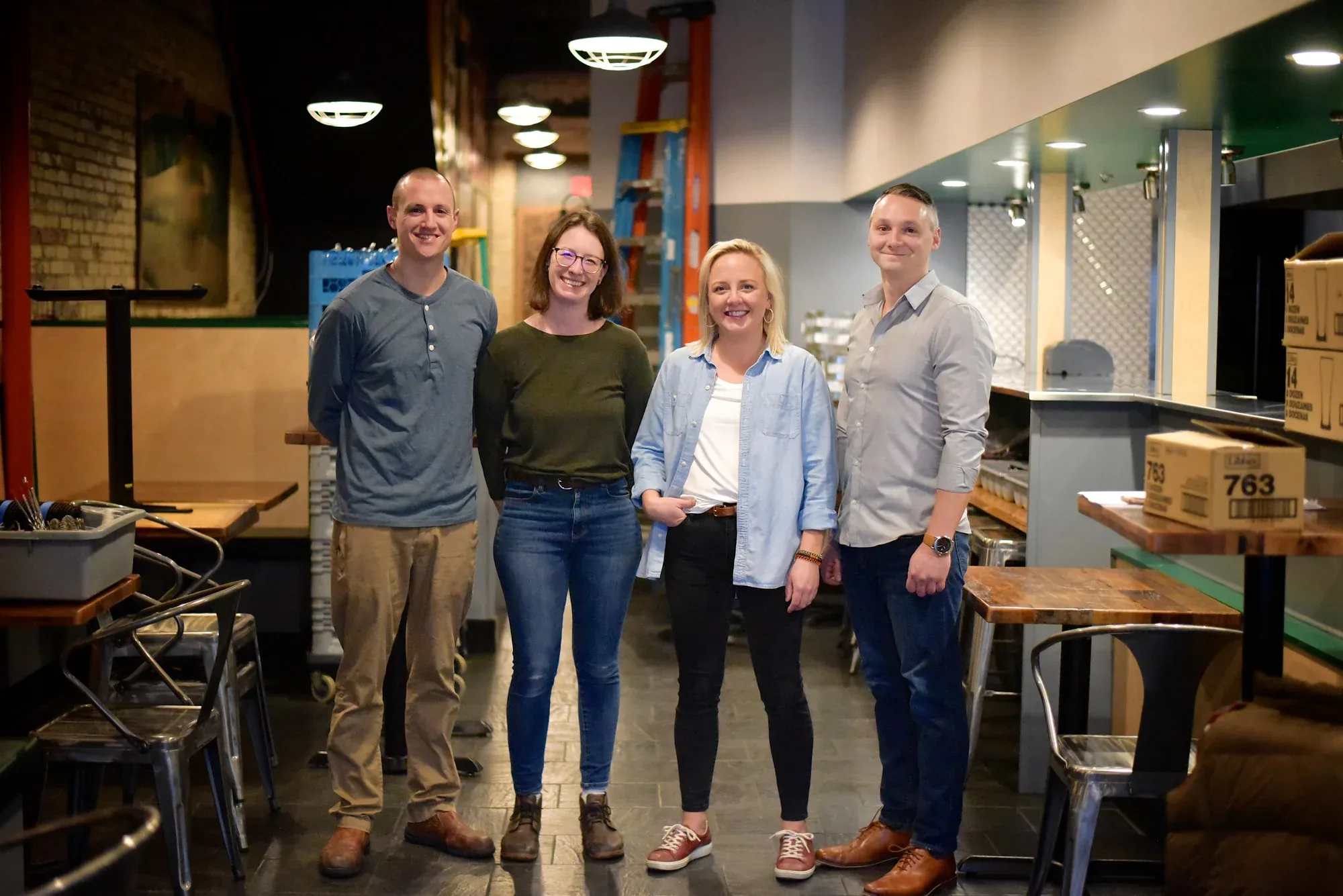 The Mama Lu’s owners and team standing together inside the restaurant