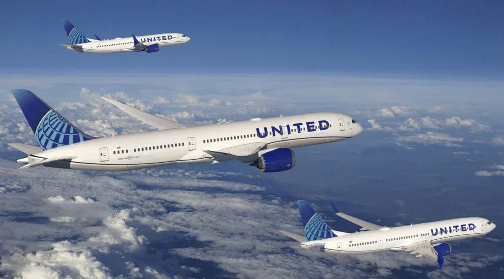 Two United Airlines planes flying above the clouds