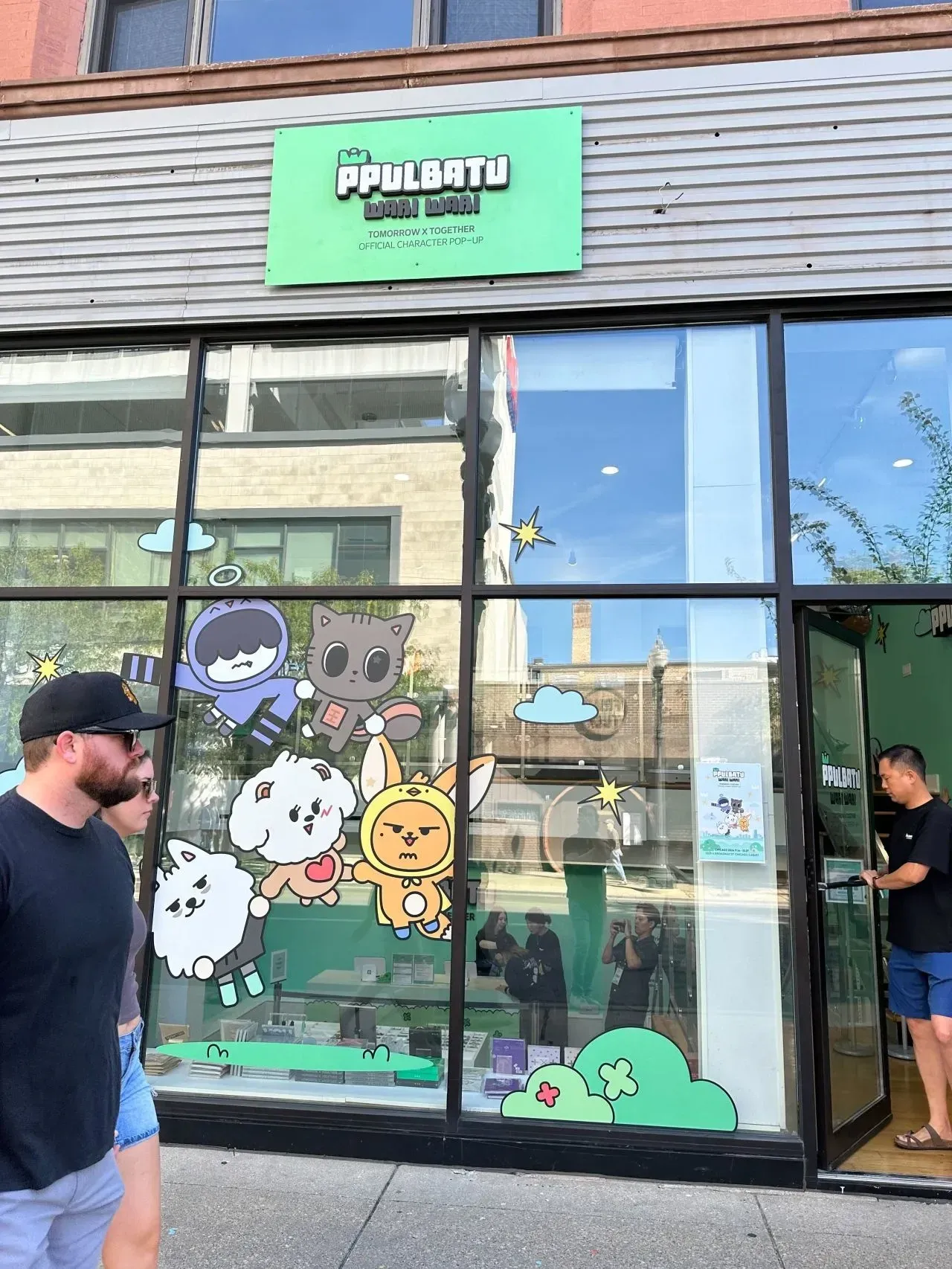 The PPULBATU pop-up storefront in East Lakeview, Chicago, its windows decorated with TXT characters