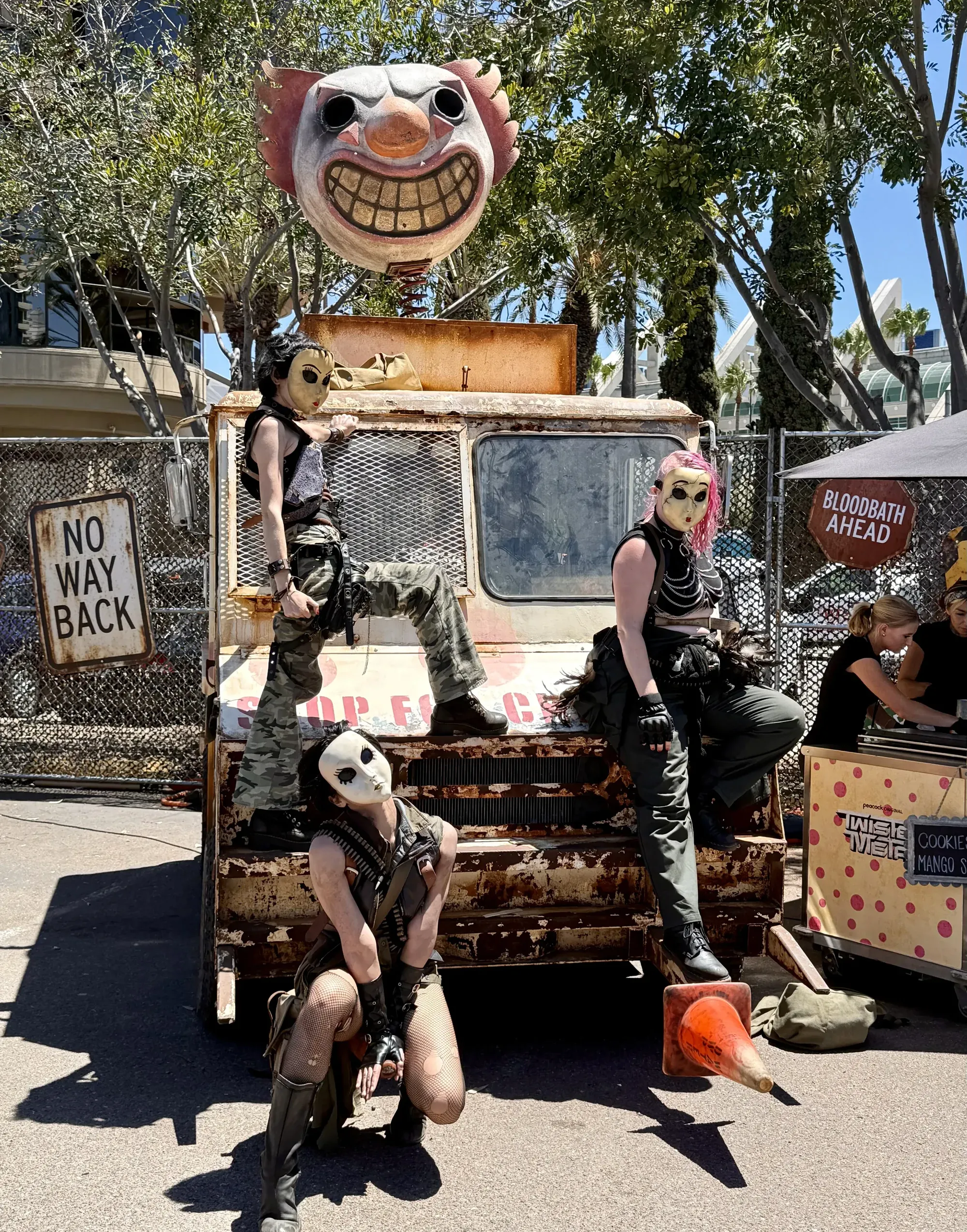 A Twisted Metal character posing in front of the Sweet Tooth ice cream truck
