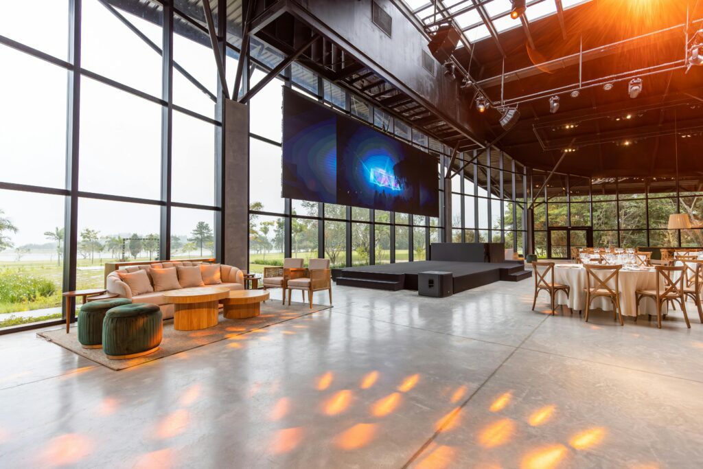 Elegant and modern conference hall with large windows and stylish furniture, ideal for events.
